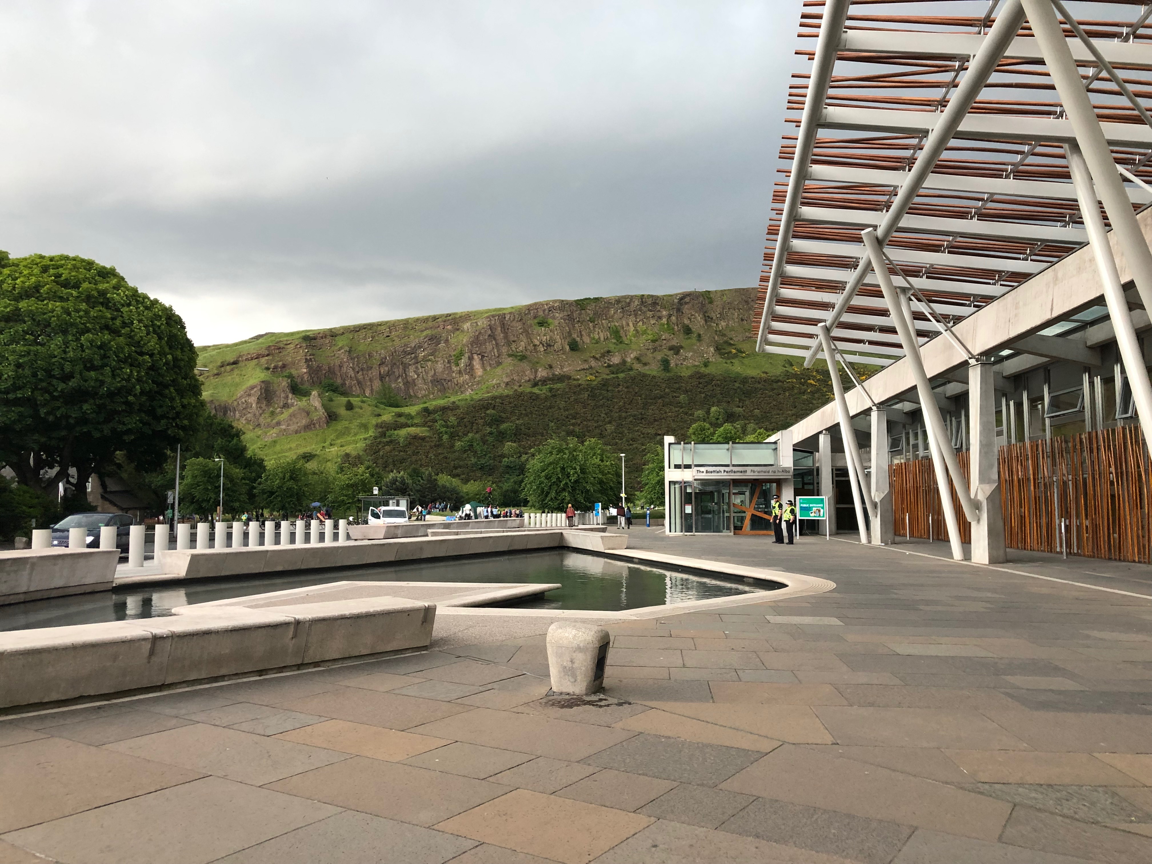 the scottish parliament building from the Canongate, with Arthur's Seat in the background
